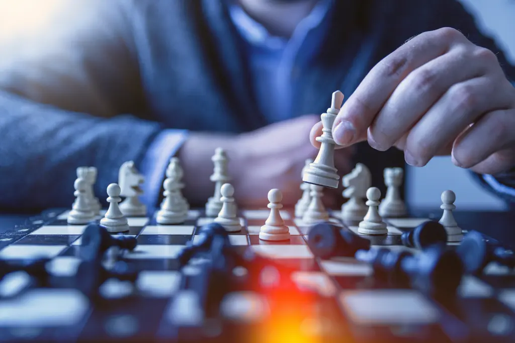 Hand moving a piece on a chessboard