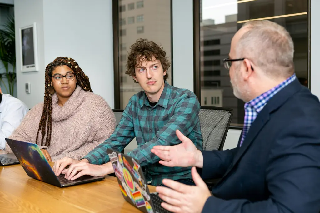 Colleagues in discussion around a meeting table